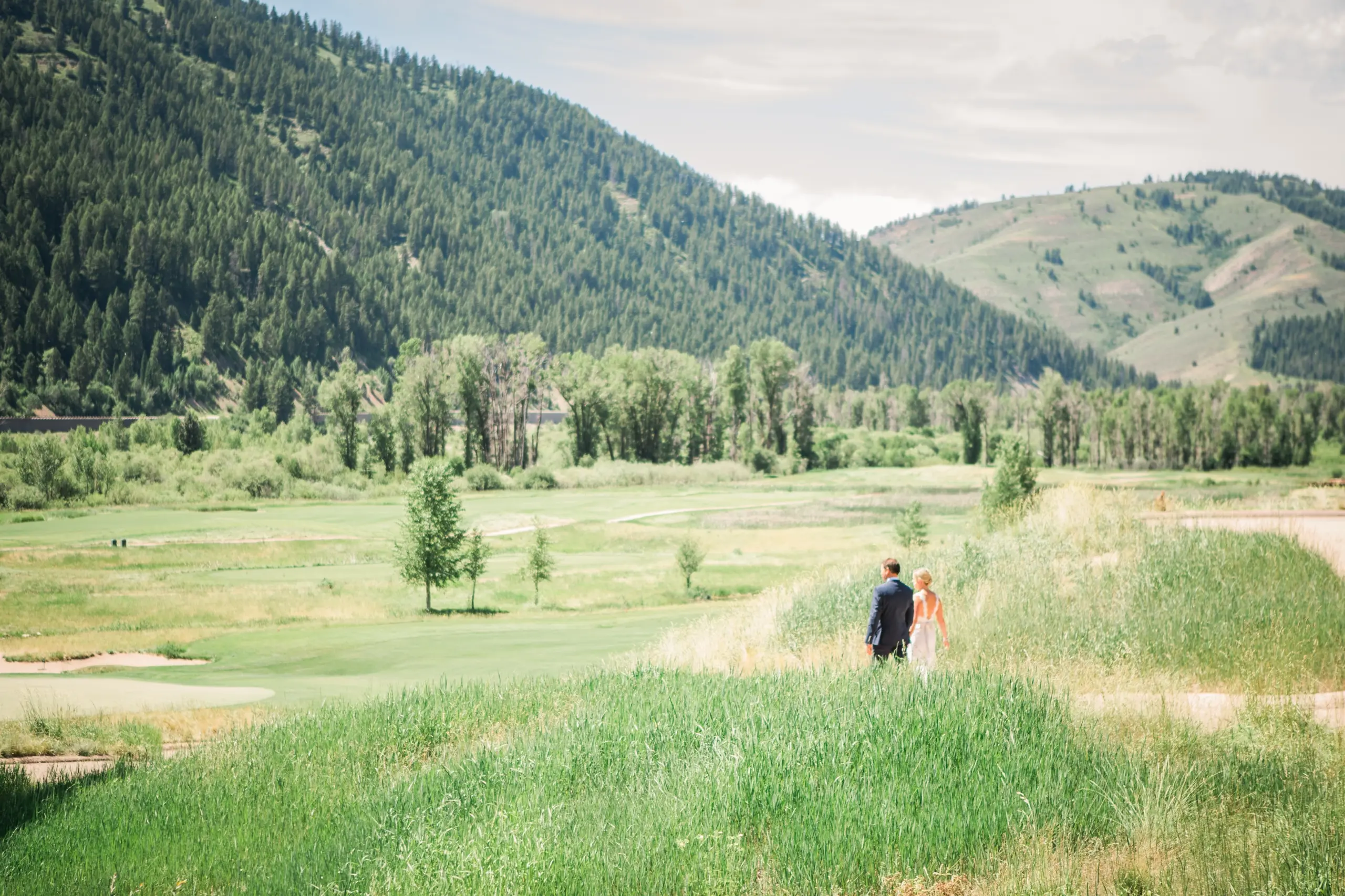 A couple walking hand in hand outdoors at Snake River Sporting Club