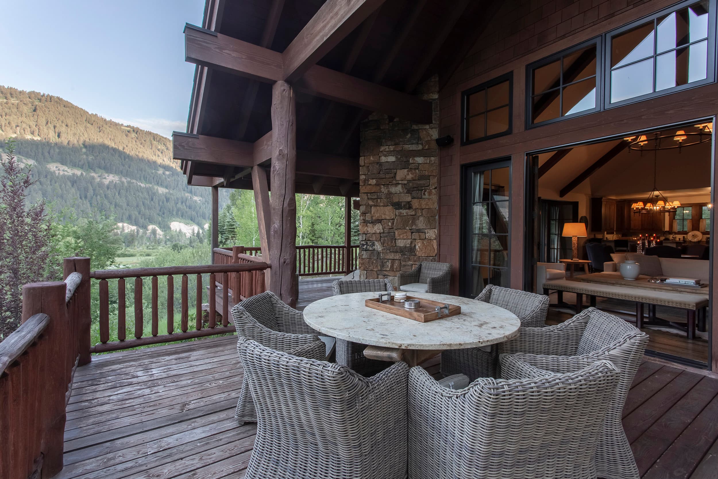 Back patio seating table to Martin Creek Cottage part of the Private Residence Collection at Snake River Sporting Club in WY.