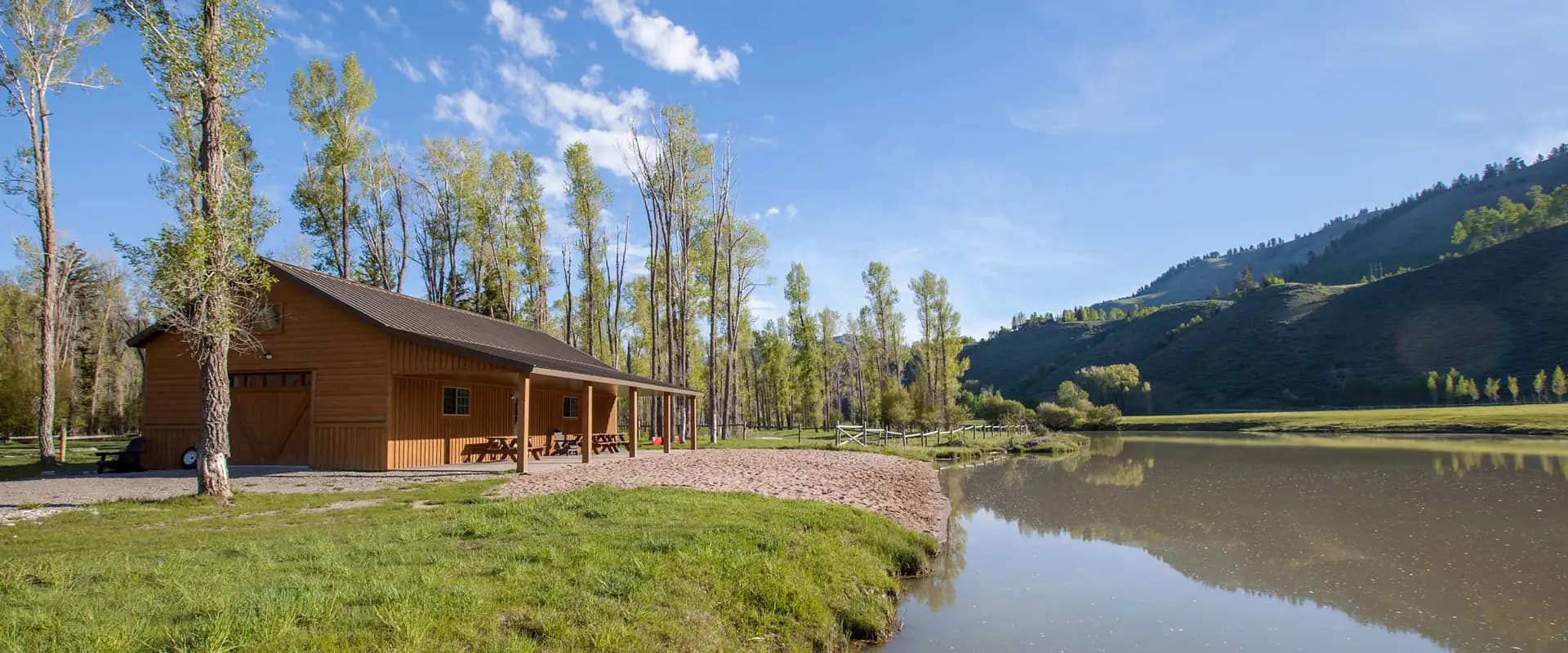 Exterior of a Pursuits Barn along side a river