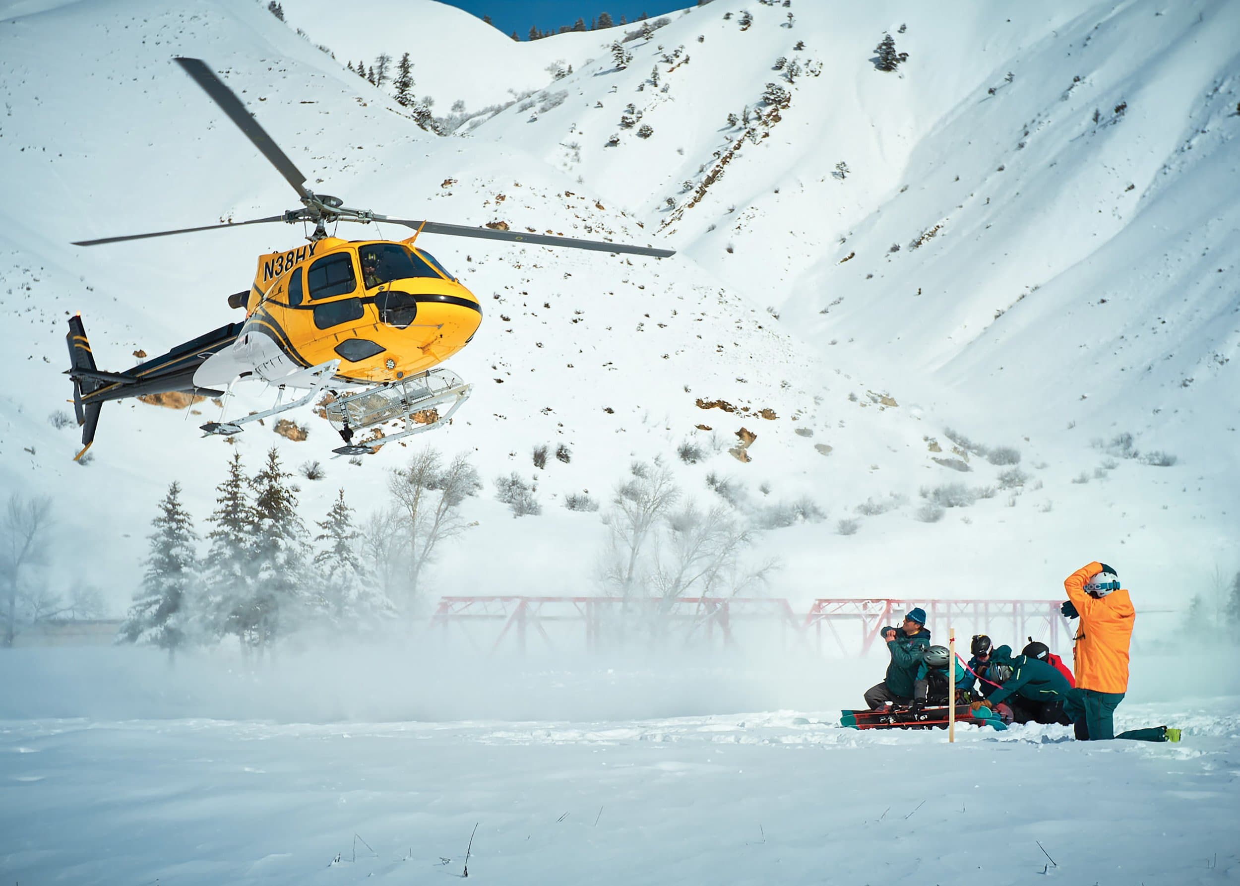 Skiers Waiting For Helicopter To Land